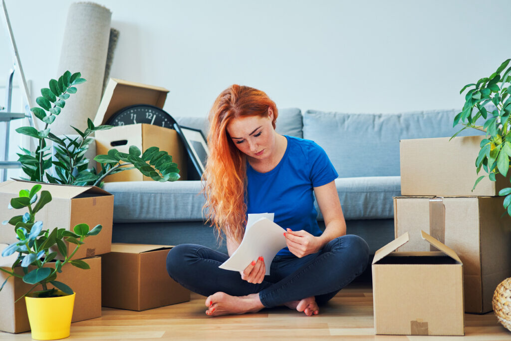 young woman looking through apartment rent agreement